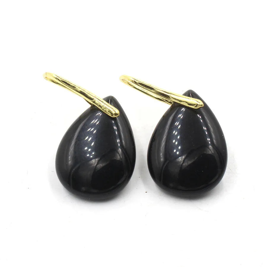 Geometric crystal water drop earrings in amethyst colour with electroplated metal setting.