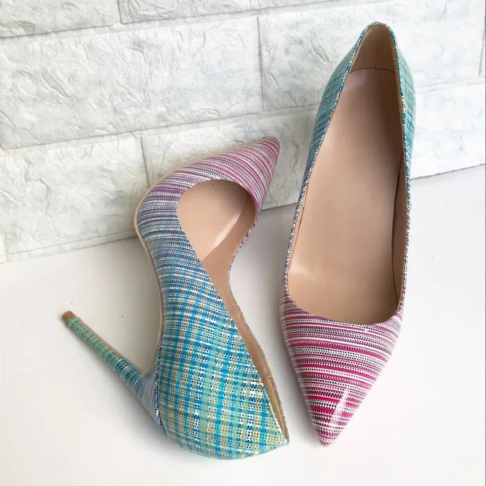 Pink and blue gradient women's high heel shoes with pointed toe and thin high heel on a plain background.
