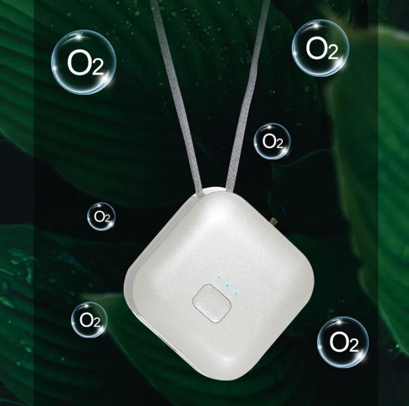 Mini USB portable air purifier necklace in pink, showing compact wearable design.
