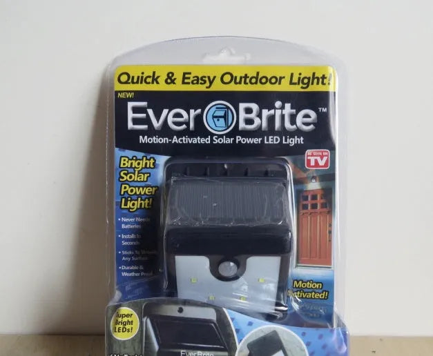 Four solar-powered LED motion sensor lights for outdoor garden and wall mounting