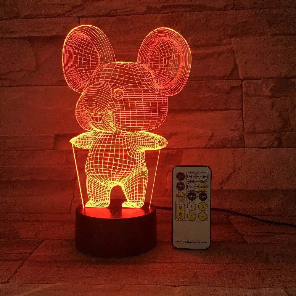 Black koala-shaped LED night light on a table showing multi-colour glow option.