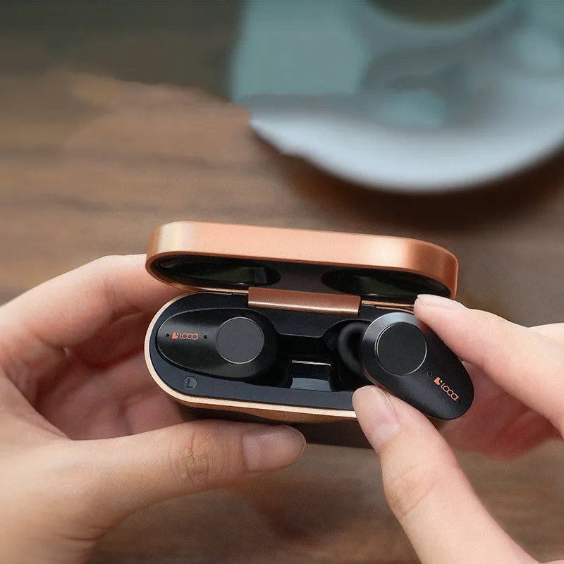 Black wireless Bluetooth stereo headset with charging case showing earbuds with rubber ear tips