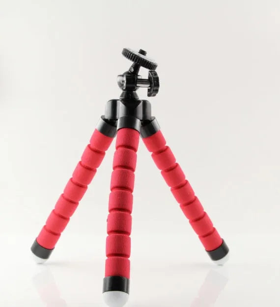 Black flexible octopus tripod with bent legs wrapped around a pole, holding a smartphone.