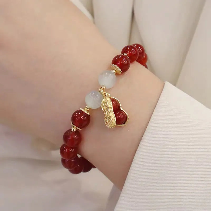 Handmade Chinese style glass bracelet with bamboo joint beads in a red Lvzhu Duobao design.