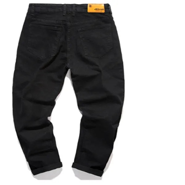 Slim-fit stretch cotton men's pants in black, laid flat showing tight cut and full length