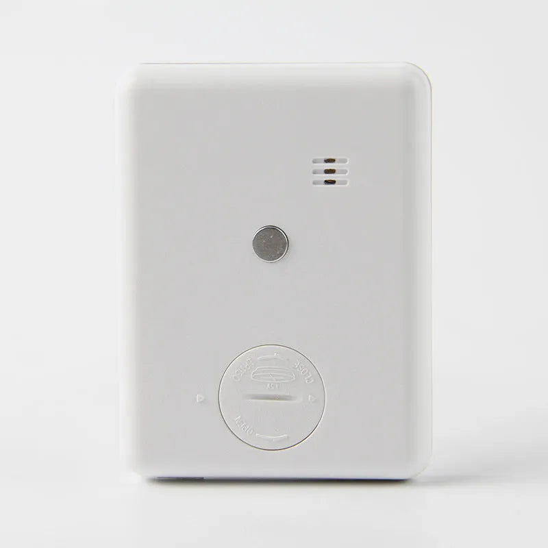Black and white magnetic kitchen timer with large digital display on a refrigerator.