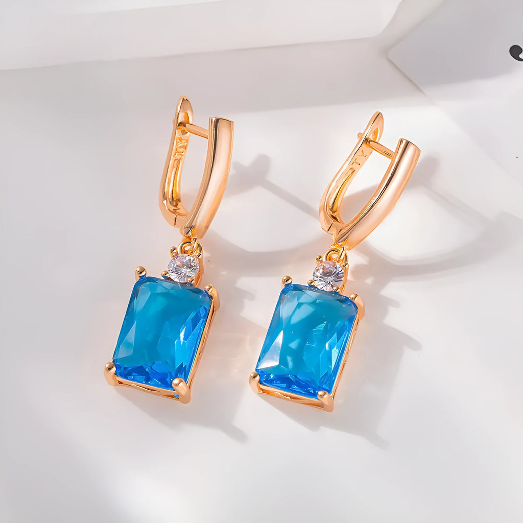 A pair of square geometric stud earrings with a quadrilateral design in an electroplated gold or silver finish.
