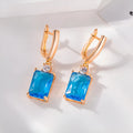 A pair of square geometric stud earrings with a quadrilateral design in an electroplated gold or silver finish.
