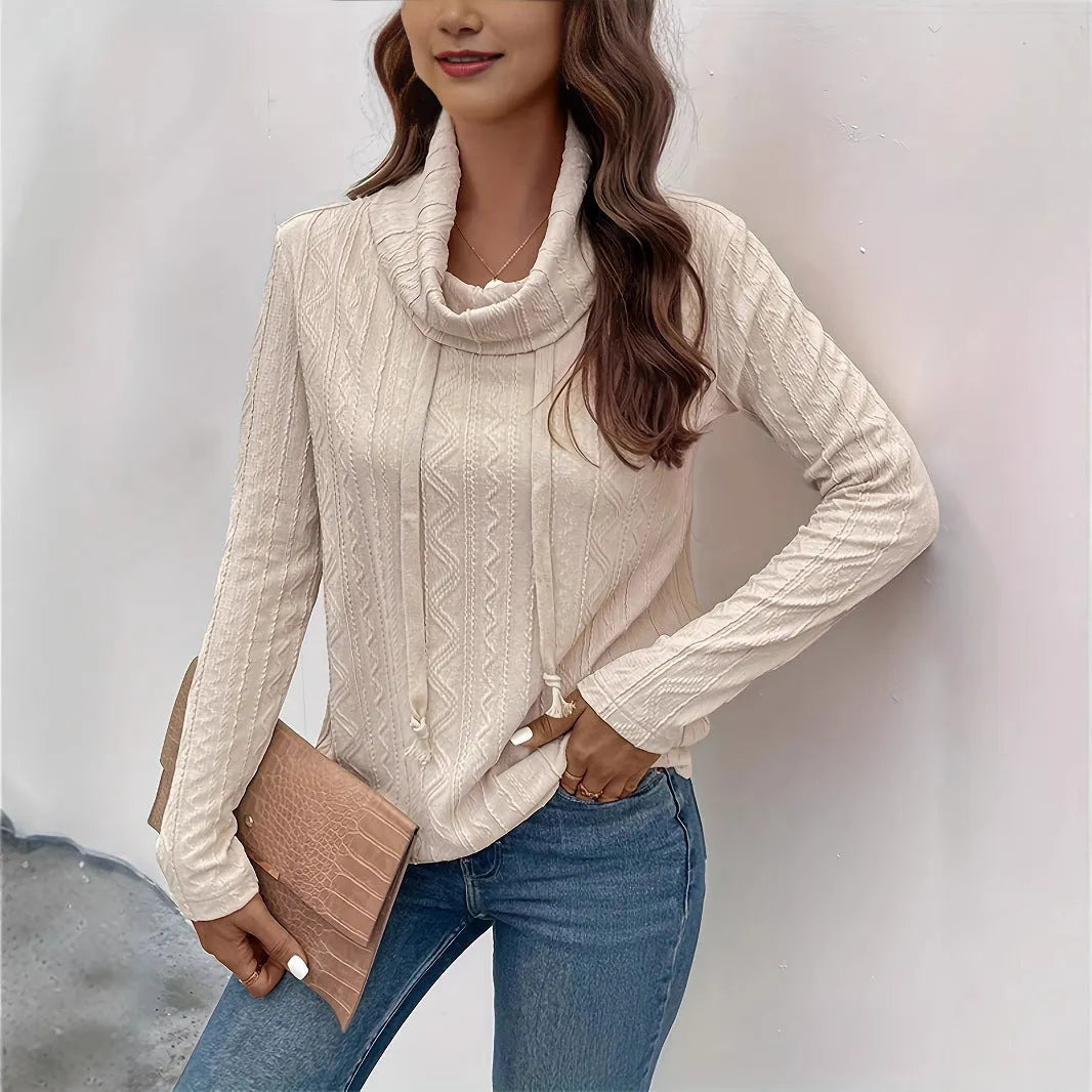 Apricot coloured long sleeve hooded pullover sweater on a hanger.