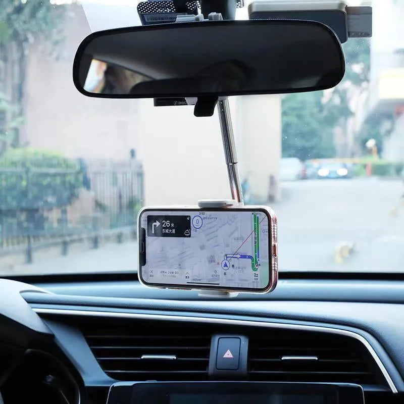 Black ABS plastic mobile phone bracket mounted on vehicle rearview mirror holding smartphone
