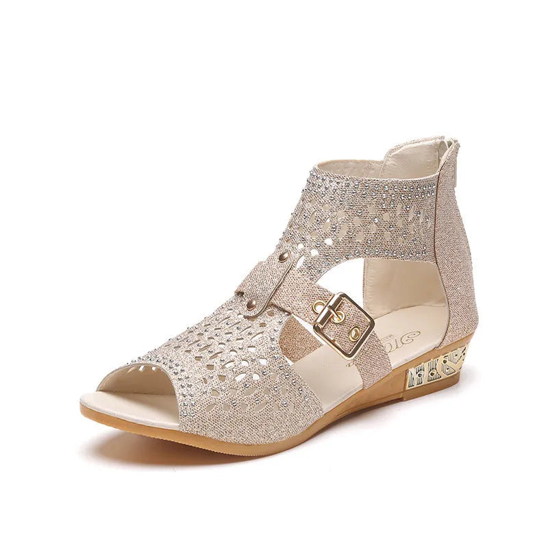 Women's beige flat sandals with wedge heel, rivet detail, and back zipper.