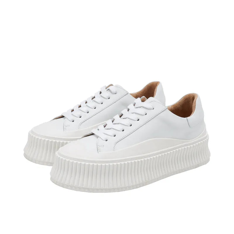 Women's black platform sneakers with back lacing and thick rubber sole