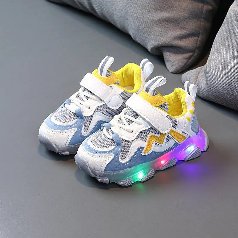 Children's bright light sports sneakers with mesh panels and Velcro strap in black, grey, or pink.