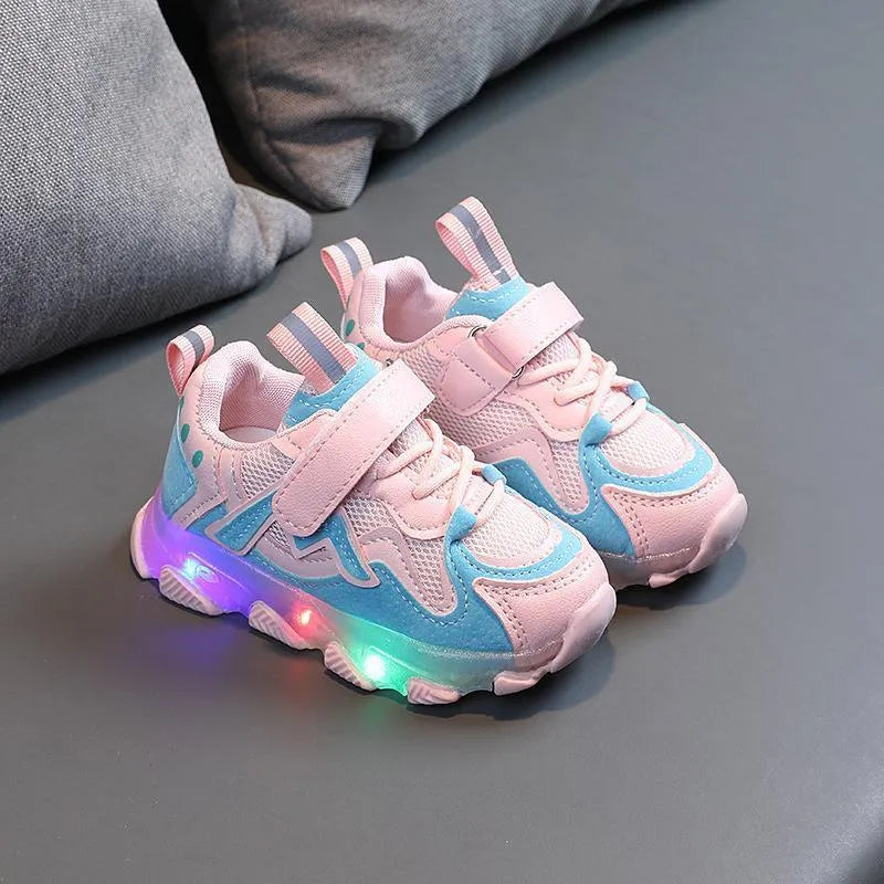 Children's bright light sports sneakers with mesh panels and Velcro strap in black, grey, or pink.