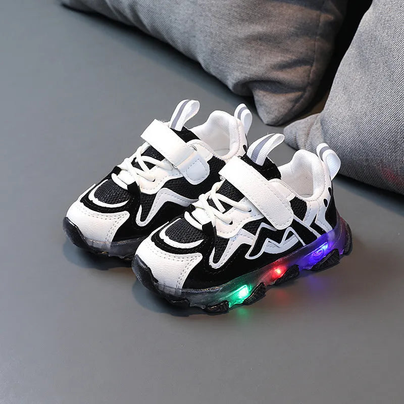 Children's bright light sports sneakers with mesh panels and Velcro strap in black, grey, or pink.