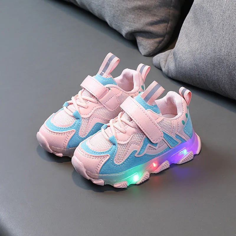 Children's bright light sports sneakers with mesh panels and Velcro strap in black, grey, or pink.