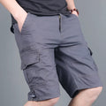Green multi-pocket cotton cargo shorts with visible zippered side pocket, flat lay on white background