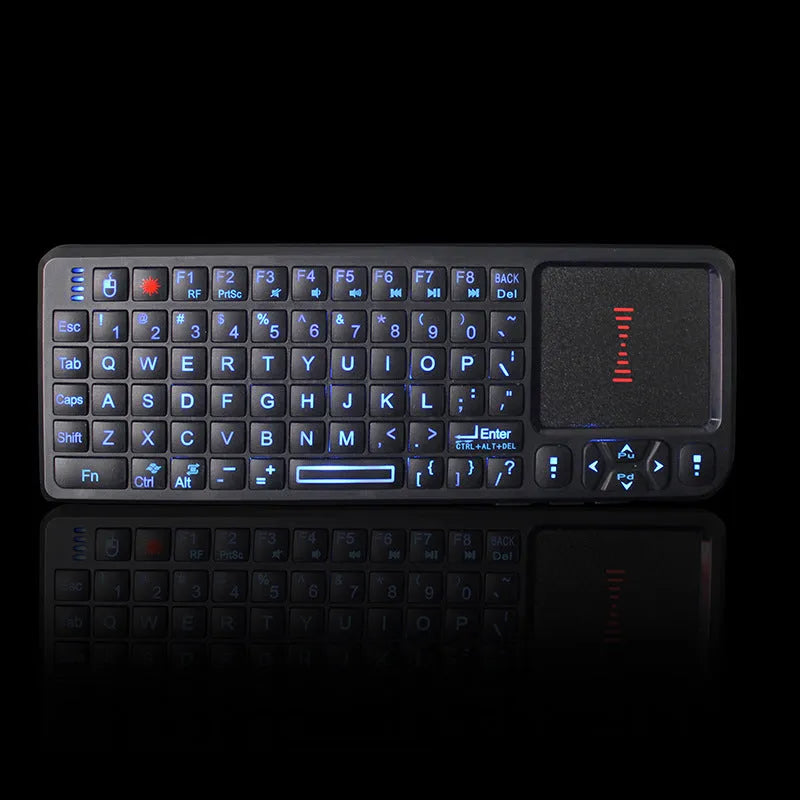 Black wireless mini keyboard with touch screen and optical mouse on a desk.