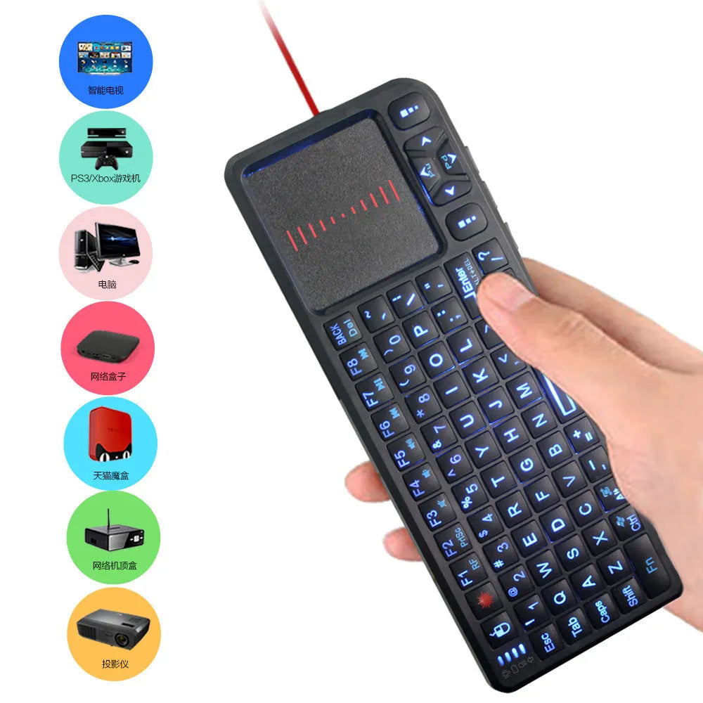 Black wireless mini keyboard with touch screen and optical mouse on a desk.