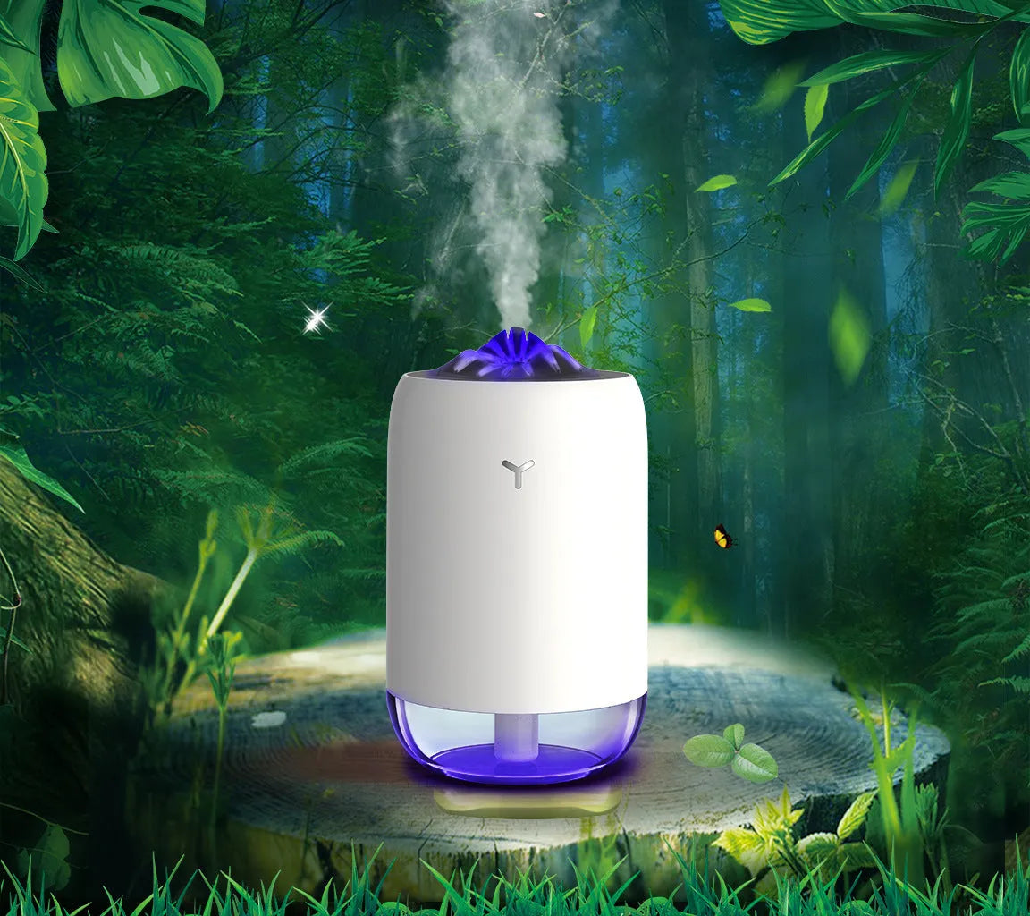 White Magic Flame columnar ultrasonic humidifier with USB cable on a wooden desk.