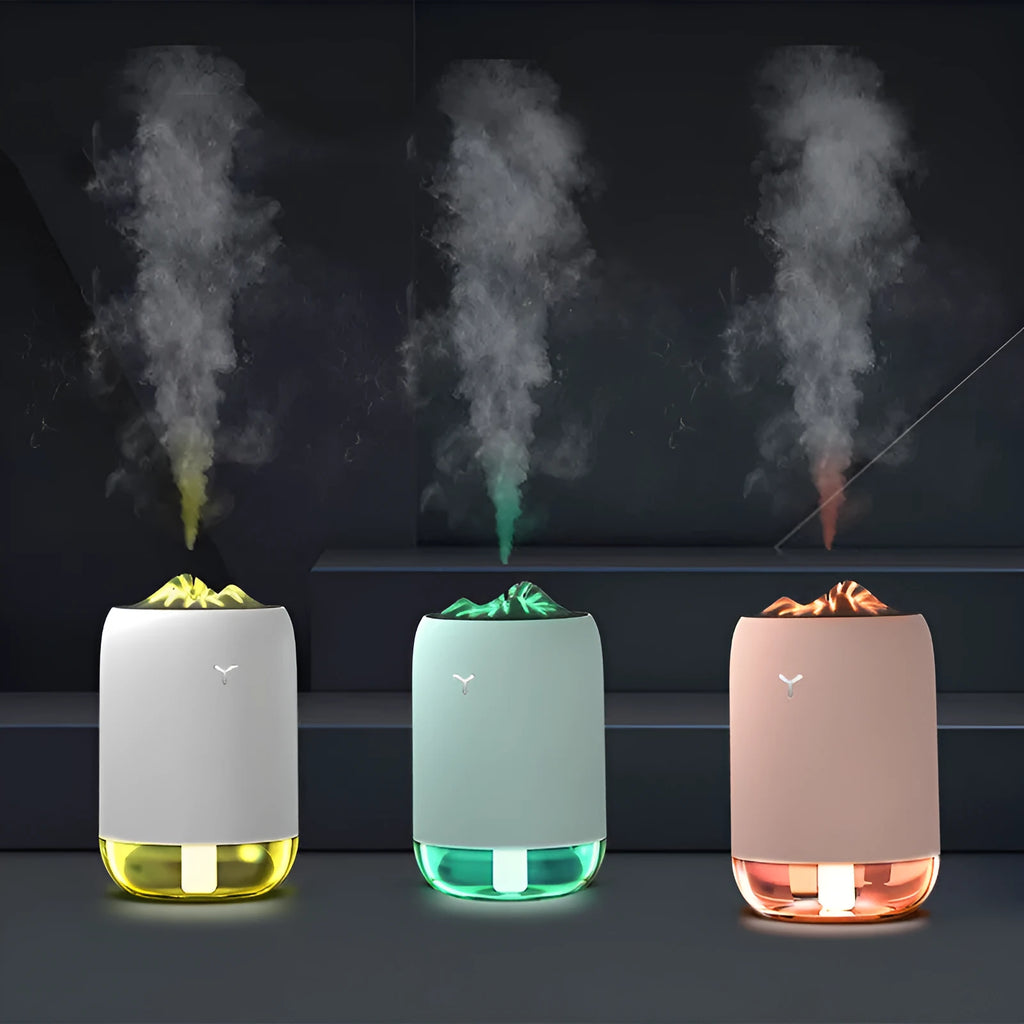 White Magic Flame columnar ultrasonic humidifier with USB cable on a wooden desk.