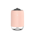 White Magic Flame columnar ultrasonic humidifier with USB cable on a wooden desk.