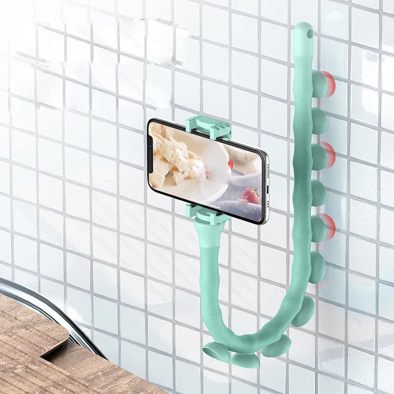 Black flexible worm arm phone holder with suction cup attached to a bicycle handlebar