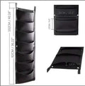 Vertical felt wall garden planter with 18 planting pockets hanging on outdoor wall