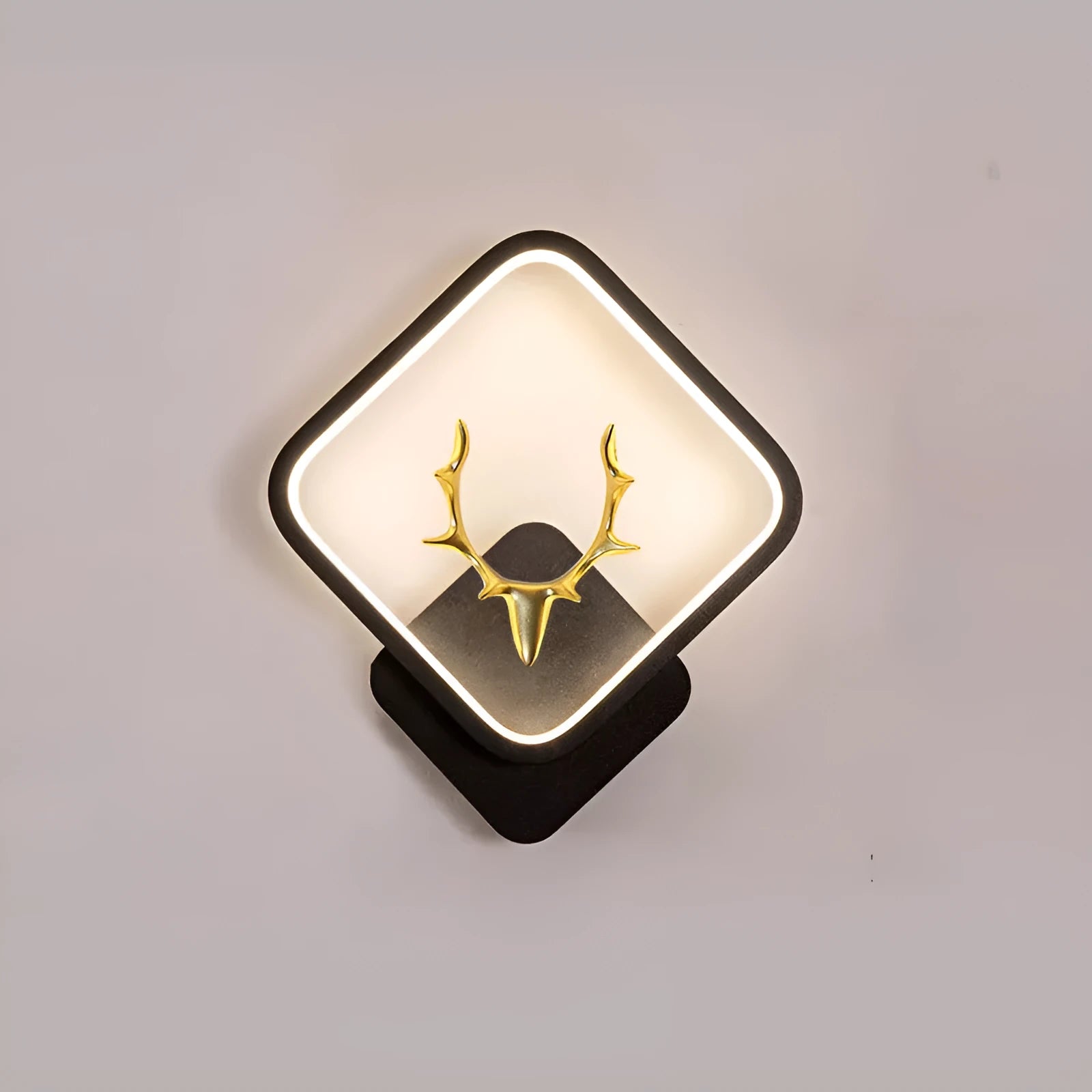 Deer antler wall lamp with remote control on wall showing three lighting colour options