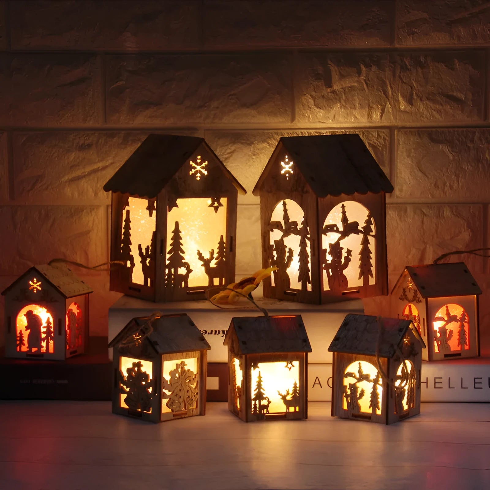 Three wooden Christmas decorations: a log bell, a Santa Claus house, and a snowman house on a festive background.