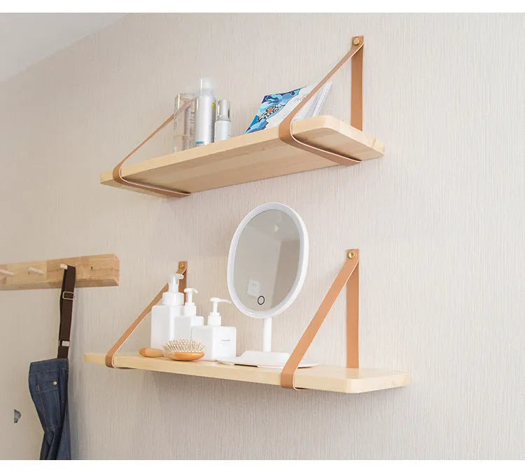 Pine wood wall-mounted storage shelf in a Nordic style, holding books and small items.