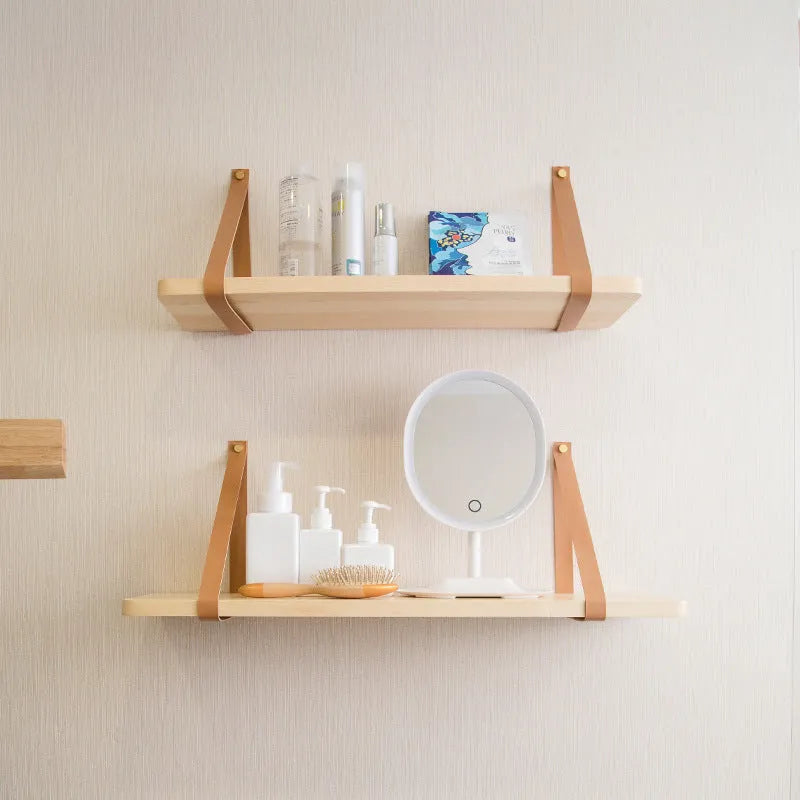 Pine wood wall-mounted storage shelf in a Nordic style, holding books and small items.