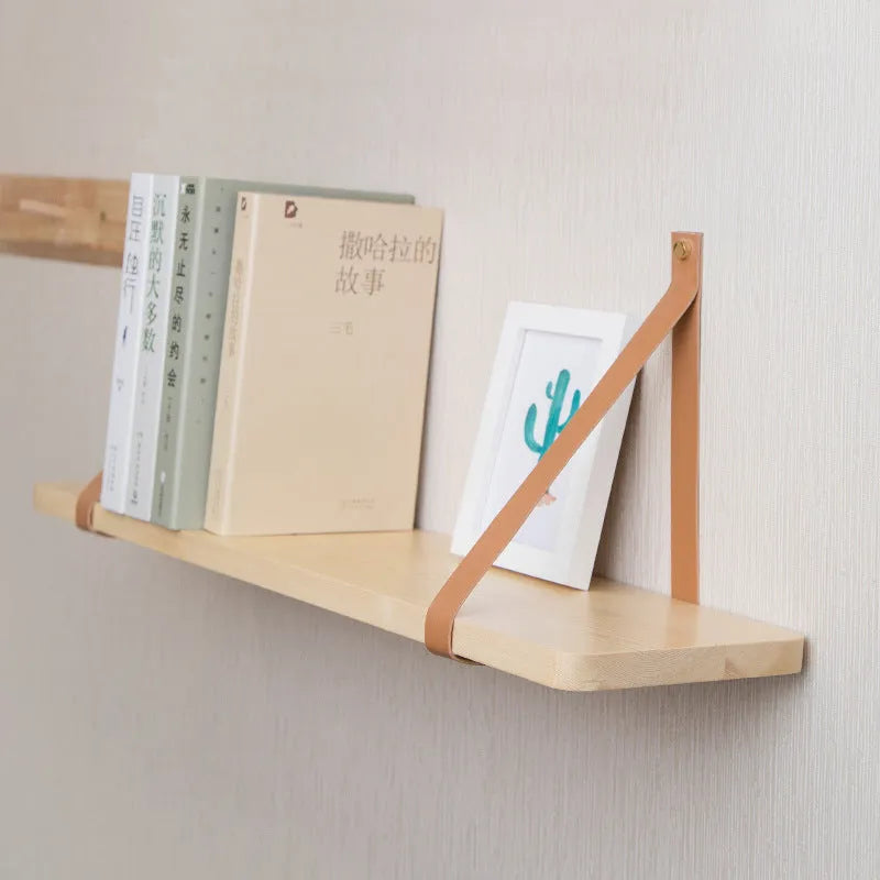Pine wood wall-mounted storage shelf in a Nordic style, holding books and small items.