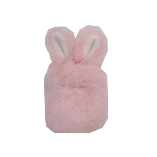 Pink silicone AirPods case cover with raised rabbit ears on a table.
