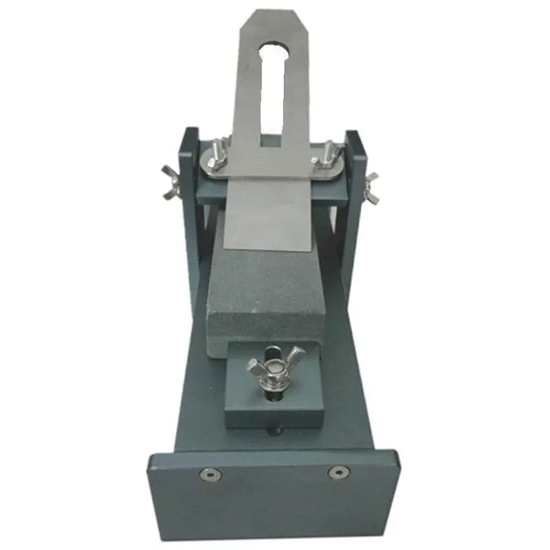 Aluminium alloy fixed angle sharpening tool for woodworking chisels and planers on a workshop bench.