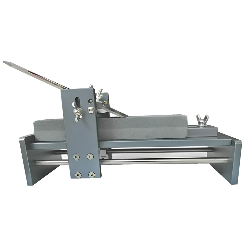 Aluminium alloy fixed angle sharpening tool for woodworking chisels and planers on a workshop bench.