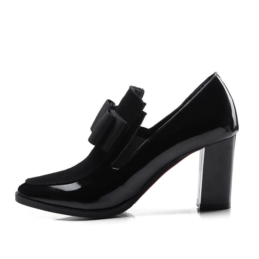 Women's black patent leather high heel with a thick square heel and rubber sole.