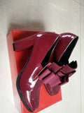 Women's black patent leather high heel with a thick square heel and rubber sole.