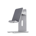Alloy mobile phone holder with adjustable bracket in dark grey or silver colour on desktop