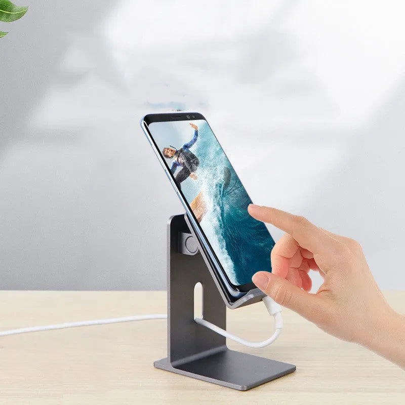 Alloy mobile phone holder with adjustable bracket in dark grey or silver colour on desktop