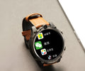 Black smart watch with 1.6-inch screen showing interface, wrist strap, and dual camera design