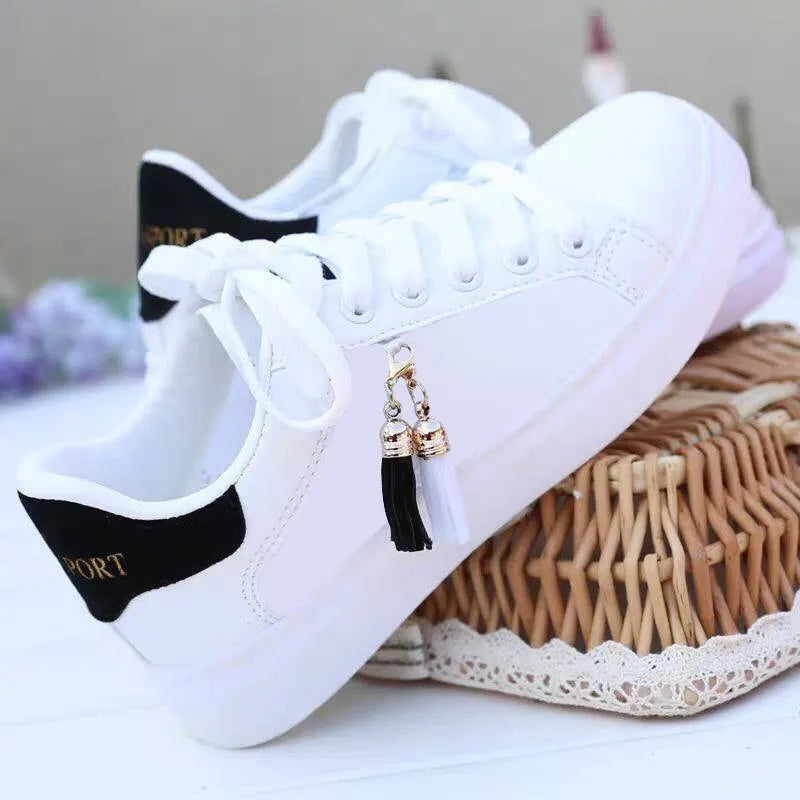White mesh flat casual shoes for women with rubber sole and breathable lining.