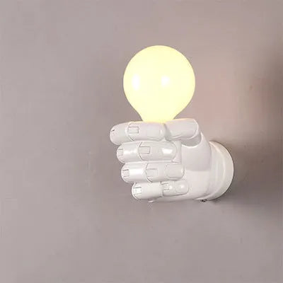 Creative fist-shaped resin wall lamp in black, mounted on a wall, for corridor or restaurant decoration.
