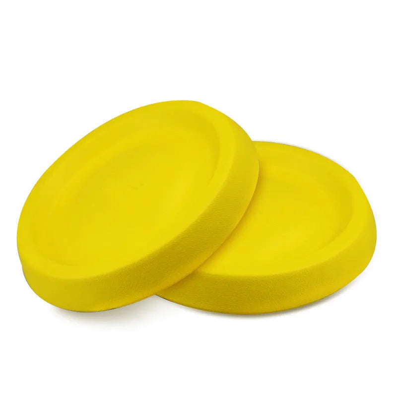 Bright yellow EVA plastic dog throwing toy for fetch games on a green lawn.