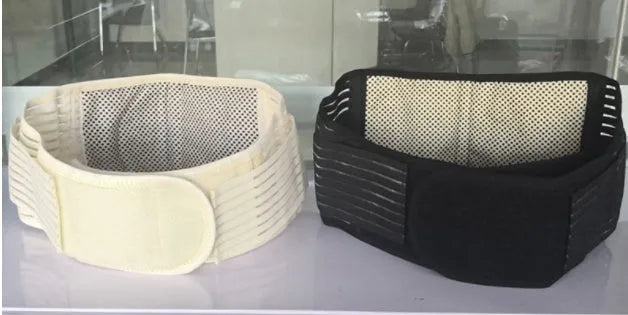 Black self-heating magnetic waist support belt wrapped around a model's lower back.