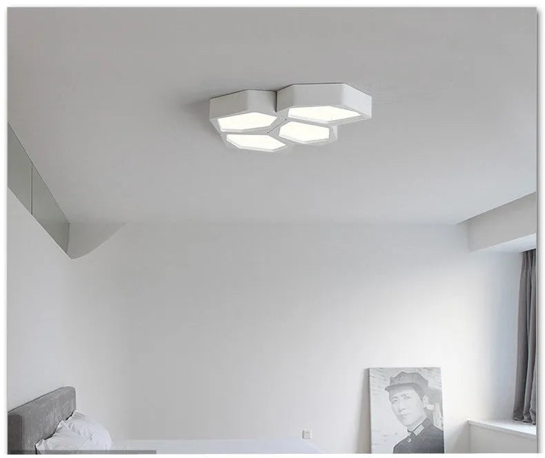 Geometric shaped iron wall light in black or white with remote control for adjustable LED lighting