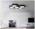 Geometric shaped iron wall light in black or white with remote control for adjustable LED lighting
