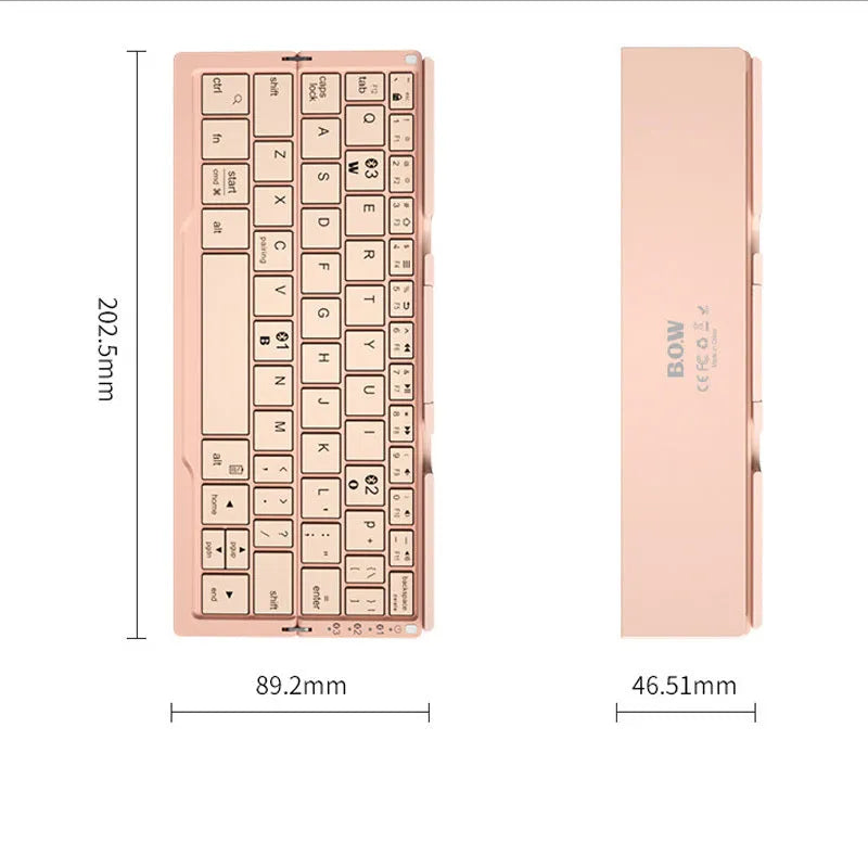 Silver white folding Bluetooth keyboard open next to a smartphone on its built-in metal stand.