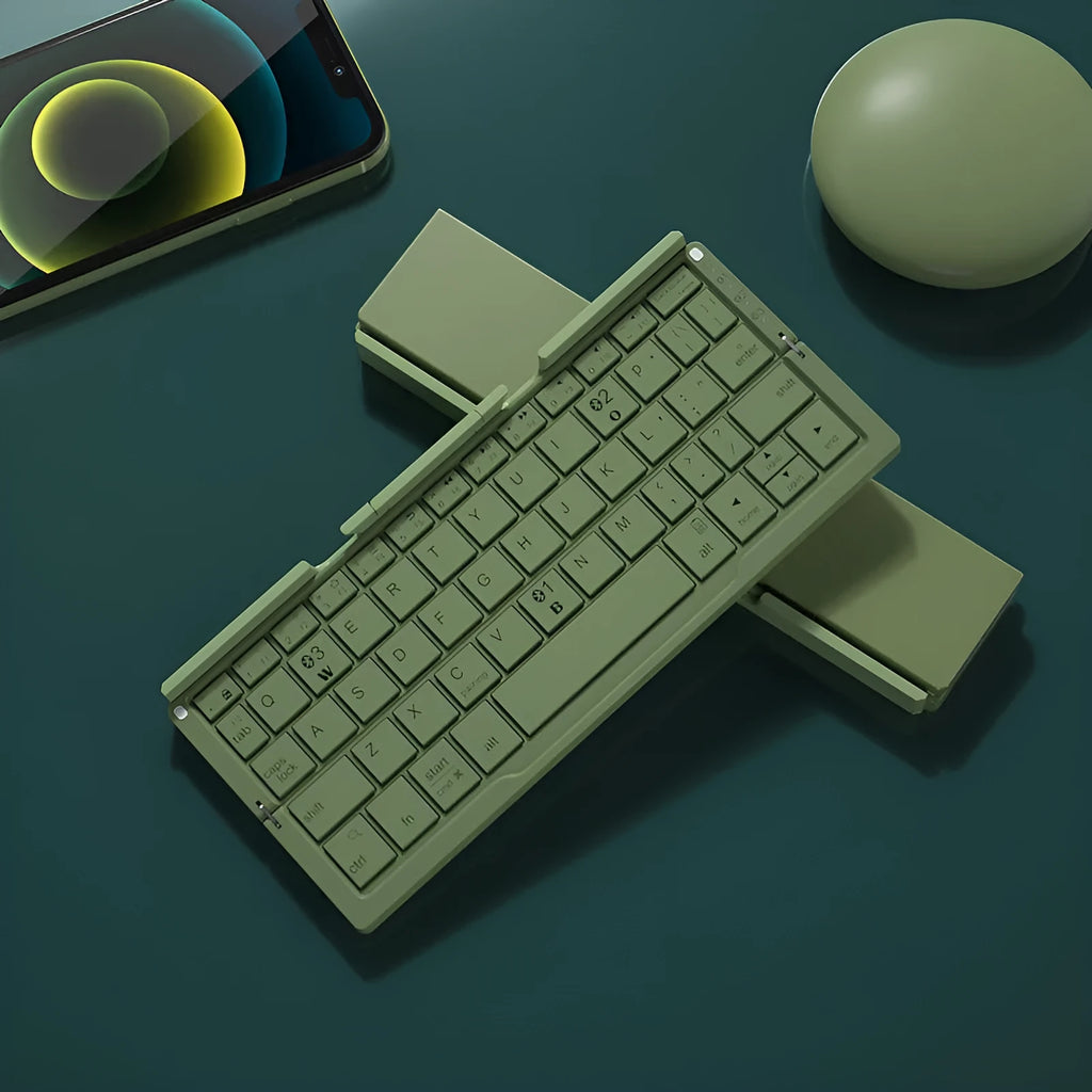 Silver white folding Bluetooth keyboard open next to a smartphone on its built-in metal stand.