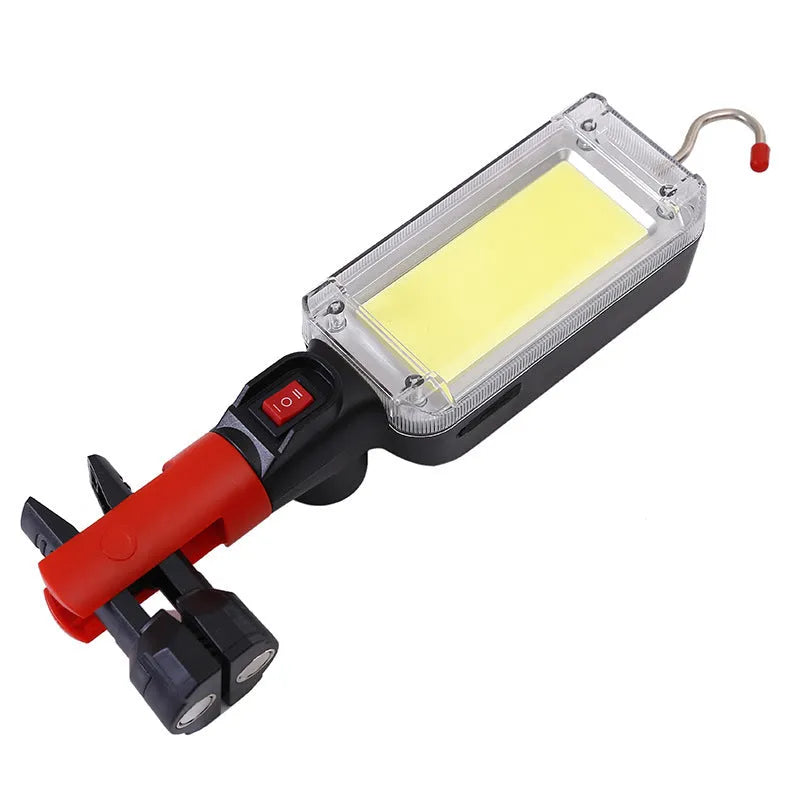 Red portable work light with magnetic base showing USB charging port and COB LED panel